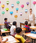 Classroom with Colorful Hot Air Balloon Cutouts Kit 60 Pcs 6 By 6 Inch Bulletin Board Decor on wall, teacher, and students.