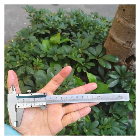 Person holding All In One Pro Grade Stainless Steel Caliper Set With Vernier And Digital Readouts Four Use Gauge outdoors