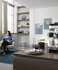 Automatic Espresso And Cappuccino Coffee Machine With Smooth Latte Crema System One Touch Brew Options Conical Burr Grinder And 13 Adjustable Settings For Killer Daily Sips In Sleek Chrome on kitchen countertop with brewed drinks.