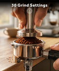 Top Tier 58mm Espresso Machine With Integrated Conical Burr Grinder, 30 Grind Settings, 20 Bar Italian Pump, PID Temp Control, Creamy Steam Wand, Legit Home Barista Setup For Killer Lattes And Dreamy Cappuccinos Zero Hassle. Hands pressing down on coffee grounds in stainless steel portafilter.