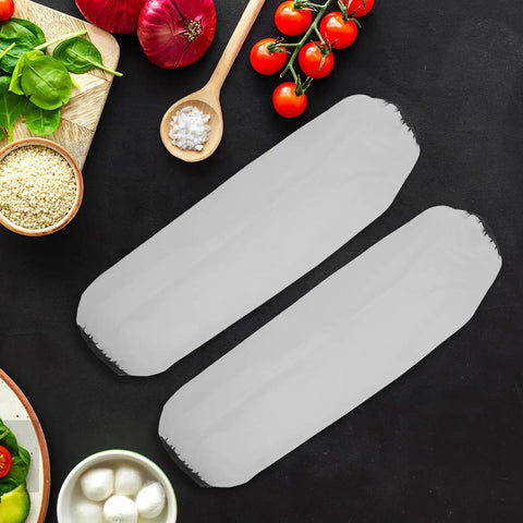 Waterproof Oilproof Arm Sleeves For Kitchen And Garage Work Hella Thick White Elastic Guards laid on a dark countertop with ingredients.