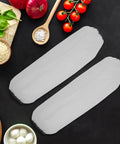 Dont Sweat The Splashes With These Heavy Duty White Waterproof Arm Sleeves Long Oil Resistant Cover For Kitchen Cooking And Garage Work Plus Garden Projects on a kitchen counter with vegetables.