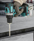 40V Max Xgt Compact Brushless Cordless 1/2 Drive Impact Wrench in use with drill bit on metal surface.