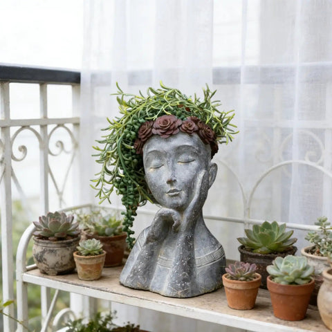 Gray concrete finish face head planter pot for succulents and small plants with drainage hole, polystone head vase and painted burgundy florals.