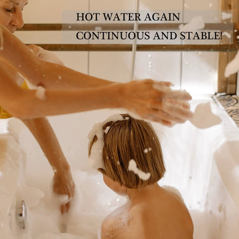 Caregiver washing a child in a bubble-filled bathtub with suds.
