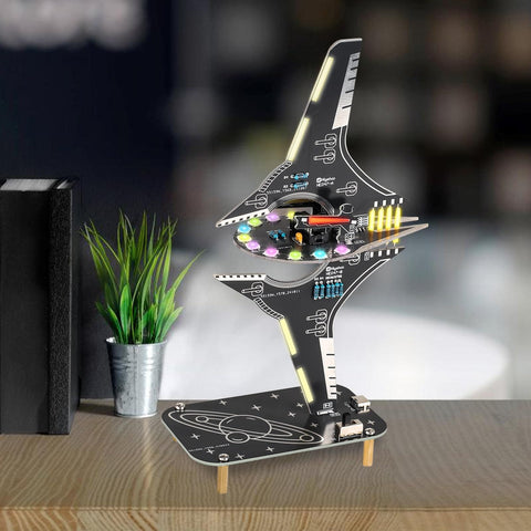 DIY Spaceship Soldering Practice Kit With LED Light Modules, Sci Fi Spacecraft Electronics Learning Kit, assembled on desk.