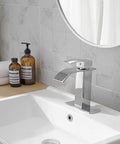 Oil Rubbed Bronze Bathroom Faucet With Waterfall Flow, One Hole, One Handle, deck mount, visible on a modern sink