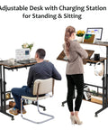 Mobile Standing Desk With Adjustable Height Rolling Desk Stand Up Station For Home Office Portable Laptop Desk On Wheels With Charging Station Rustic Brown in use by seated and standing individuals.