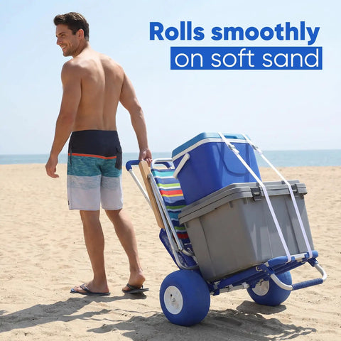 Man pulling Massive Heavy Duty Beach Wagon With 12 Inch Big Wheels For Sand Balloon Tires on sandy beach