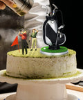 Mini Golf Pen Holder Desk Accessory Set With 3 Golf Club Pens And Ball On A Mini Putting Green Base on a cake, humorous decor