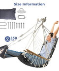 Person sitting in a Patio Swing Chair With Adjustable Footrest And Headrest For A Comfy Cloudlike Sit Quilted Fabric And Steel Spreader Bar Wooden Armrests For Porch Or Garden 350 Lb Capacity Hardware Kit Included 2025 Upgrade.
