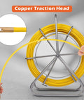Hands holding 425 Ft Fiberglass Fish Tape with copper traction head, mounted on steel wheel stand.