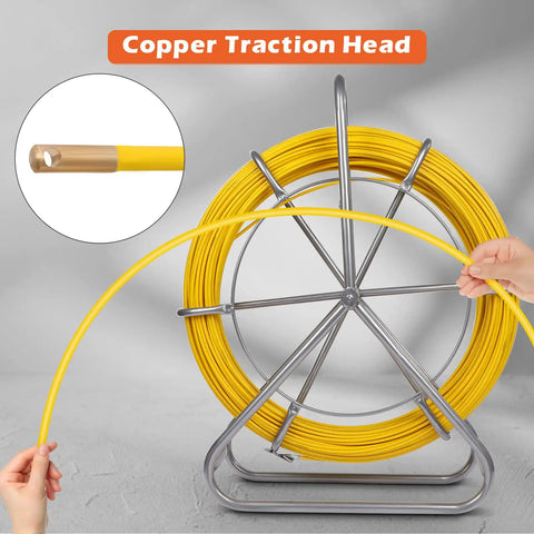 Hands holding 425 Ft Fiberglass Fish Tape with copper traction head, mounted on steel wheel stand.