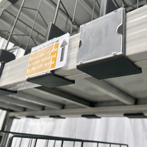 Twenty Pack Heavy Duty Wire Shelf Dividers With Double Buckle Clips For Store Fixtures And Library Shelving Includes Erasable Price Labels, showing clips and labels on a wire shelf.