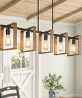 53 Inch Farmhouse Kitchen Island Light Five Light Adjustable Dining Room Wood And Black Metal Chandelier in rustic setting.