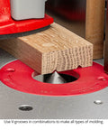 7 Piece 90 Degree V Groove Router Bit Set Featuring Premium Carbide Cutters In Quarter And Half Inch Shanks For Engraving Lettering Miter Joinery American Made Kit That Cuts Like Butter On Cnc Desktop Or Handheld Routers, in use on oak wood.
