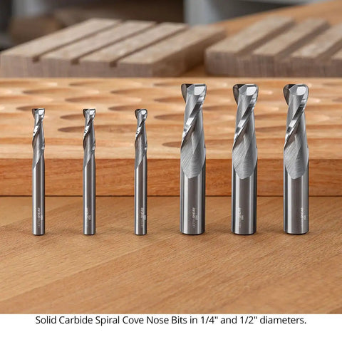 Top Shelf 1/2 Inch Shank Solid Carbide Spiral Cove Nose Router Bit Set Featuring 1/16 3/32 And 1/8 Corner Radius Bits For Smooth Flawless Woodworking Cuts Made In Usa displayed on a wooden surface.