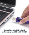 Ten Pack 64GB USB 3.0 Flash Drives Blue 70MB/s Read Speed Slim Thumb Drives For Quick Data Transfer And Backward Compatibility With USB 2.0 Ideal For School Work And Travel, purple 64GB USB drive in hand near laptop
