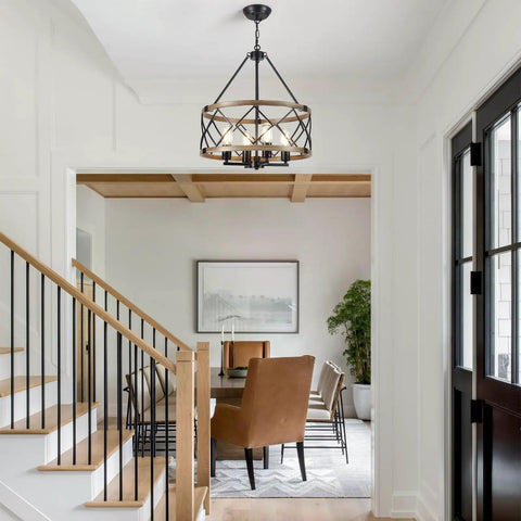 Dining room with Black Farmhouse Chandeliers For Dining Room Light Fixture With Six Candle Style Heads above table and chairs.