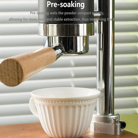 Badass Stainless Steel Manual Lever Espresso Maker With Integrated Pressure Gauge pouring into white cup with wooden handle.