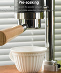 Portable Manual Espresso Maker With Stainless Steel Lever And Precision Pressure Gauge For Rich Extraction Of Espresso And Latte Road Ready Build Delivers Straight Up Quality Shots And Real Deal Flavor Everyday close-up of lever and cup during pre-soaking process.