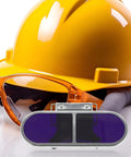 Industrial Grade Welding Goggles Featuring Adjustable Screw Clip Clamp Design To Keep Your Peepers Protected During Heavy Steelworking Grind Tough As Nails Professional Eye Shielding For Dedicated Builders And Trades Pros with orange safety glasses and yellow hard hat.