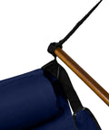 Close-up view of blue hanging hammock chair with wooden dowels, 350 lb capacity, showing pillow and rope attachment.