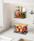 Two Pack Stackable Trash Bag Holder And Dispenser With Bamboo Top For Laundry And Kitchen Storage No Drill Wall Mount Organizer Great For Small Spaces And Busy Kitchens Keeps Bag Rolls Ready shown mounted on kitchen wall with fruit inside.