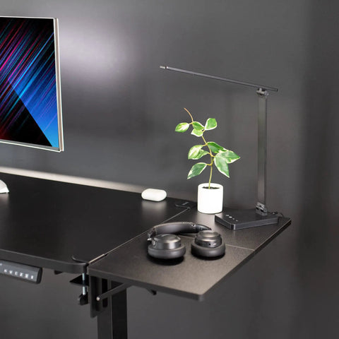 Boss Move Heavy Duty Clamp On Desk Extender With Foldable Keyboard Tray And Padded Wrist Support Expands Workspace For Sit Stand Tables Smooth Setup All Day Grind Black on black desk with headphones and lamp.