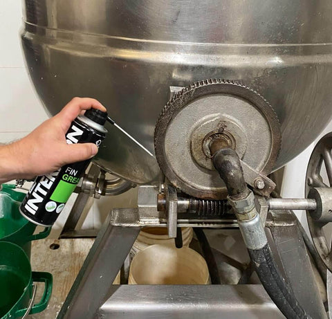 Hand applying Industrial Food Grade Workhorse Grease Spray With MicPol Technology to machinery gear, 300 ML aerosol can