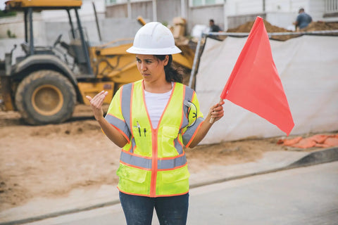 Woman wearing Mens Built Tough High Visibility Mesh Vest With Six Cargo Pockets And Secure Zipper Ansi Class Three top shelf safety wear.