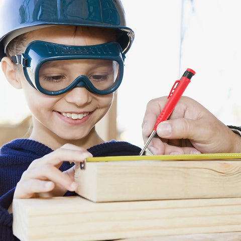 Smiling girl wearing safety gear using a Rock Solid 2.8mm Carpenter Pencil Lead Refills 36 Piece Bulk Pack to mark wood.
