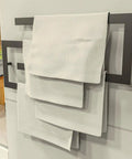 Modern Towel Shelf With Matt Black Finish Four Tier Wall Mounted Towel Rails And Shelves Rack displayed in bathroom