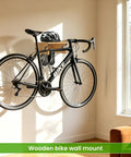 Wood Bike Wall Mount With Shelf And Hooks, All In One Road Bike Storage Rack For Helmets, Shoes, Gloves, Goggles, And Gear, in living room.
