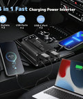 Road Warrior Approved 500 Watt Power Inverter For Cars Converting DC 12V To 110V AC With PD 20W Fast Charging USB Ports And Dual AC Outlets Zero Drama Plug And Play Adapter in a car charging a phone and laptop.