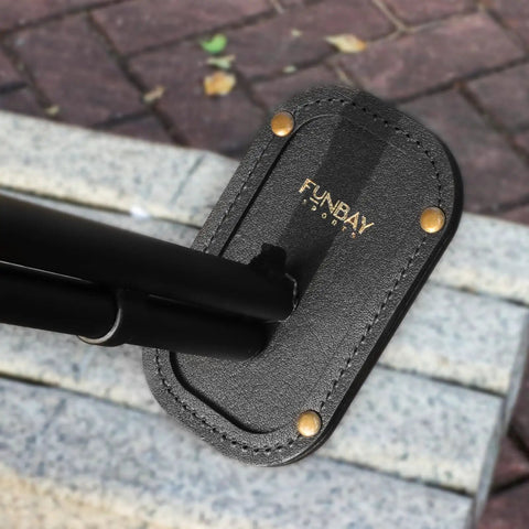 Magnetic Leather Barrel Rest for Shotguns, black leather with brass accents and visible logo, for Sporting Clays, Trap, Skeet, Five Stand.