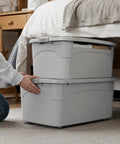 Heavy Duty Stackable Storage Totes With Secure Hinged Lids And Smooth Rolling Casters Plus Reinforced Side Handles For Clutter Free Closet Organization And Dorm Spaces being organized under a bed.
