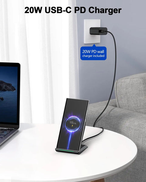 Two Coil Fast Wireless Charger Stand With 20W PD Adapter Included For IPhone 17 Pro Max 17 16 15 14 13 And Samsung Galaxy S21 To S26 Desk Dock, charging a phone on a desk next to a laptop and sofa.