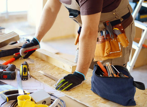 Person using tools with a blue canvas pouch, part of a 4 Pack Canvas Tool Pouches With Zippers, 16 oz heavy duty organizers on table.