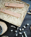 All In One Leather Stamping Kit With Rubber Hammer 71 Piece Set With 68 Patterns And Shapes shown with stamped leather strips.