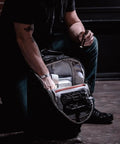 Person using ProTac 1L-1AA 350-Lumen Compact Tactical LED Flashlight With Alkaline Battery Coyote Finish Built For EDC in a dark room.