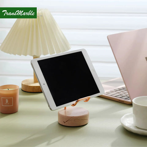 Marble Phone Stand With Metal Holder Charges While You Use It, Marble base with rose gold frame on office desk with tablet.