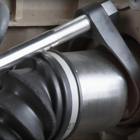 Close-up of inner axle removal using Inner CV Axle Puller Tool Set With Slide Hammer 4 Lb And Two Inch And Two And A Half Inch CV Joint Fork Adapters