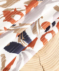 Close-up of Privacy Boho Curtains 84 Inches Long 2 Panels Set Orange Brown Light Filtering Drapes with floral pattern on fabric.