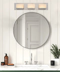 Everett 24 Inch Modern 3 Light Integrated LED Vanity Light with Brushed Nickel Finish above a bathroom mirror.