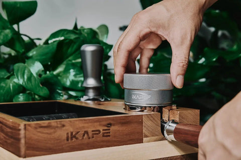 Hands using 53mm Gravity Adaptive Espresso Distributor for 54mm Portafilters, Fits Breville Bottomless Portafilter, 304 Stainless Steel Coffee Tool