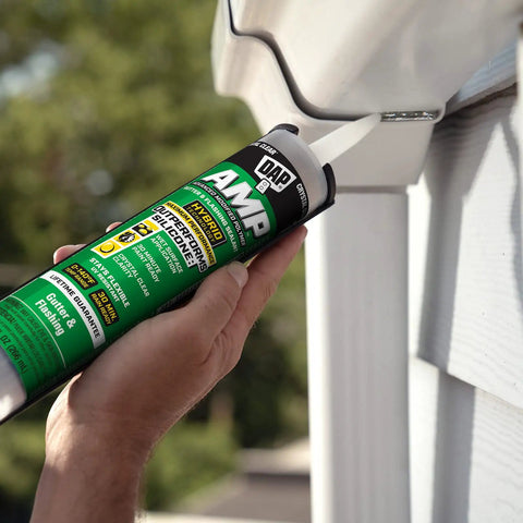 Applying gutter and flashing sealant in clear 9 oz tube extreme temperature flexible hybrid polymer caulk for roof and gutter sealing