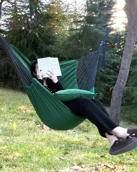 Two Cushions Included Hammock Chair With Soft Cotton Handwoven Fabric Indoor Outdoor Hanging Rope Swing For Bedroom Porch Patio Super Comfy Sturdy And Durable Lounge Chair with person reading outdoors.