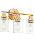Brass three light vanity light with clear glass shades for a modern bathroom over mirror, ideal for bright task lighting and soft ambience.