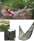 Army Green Outdoor Travel Hammock With Mesh Net Nylon Rope Construction shown hung between trees with person relaxing